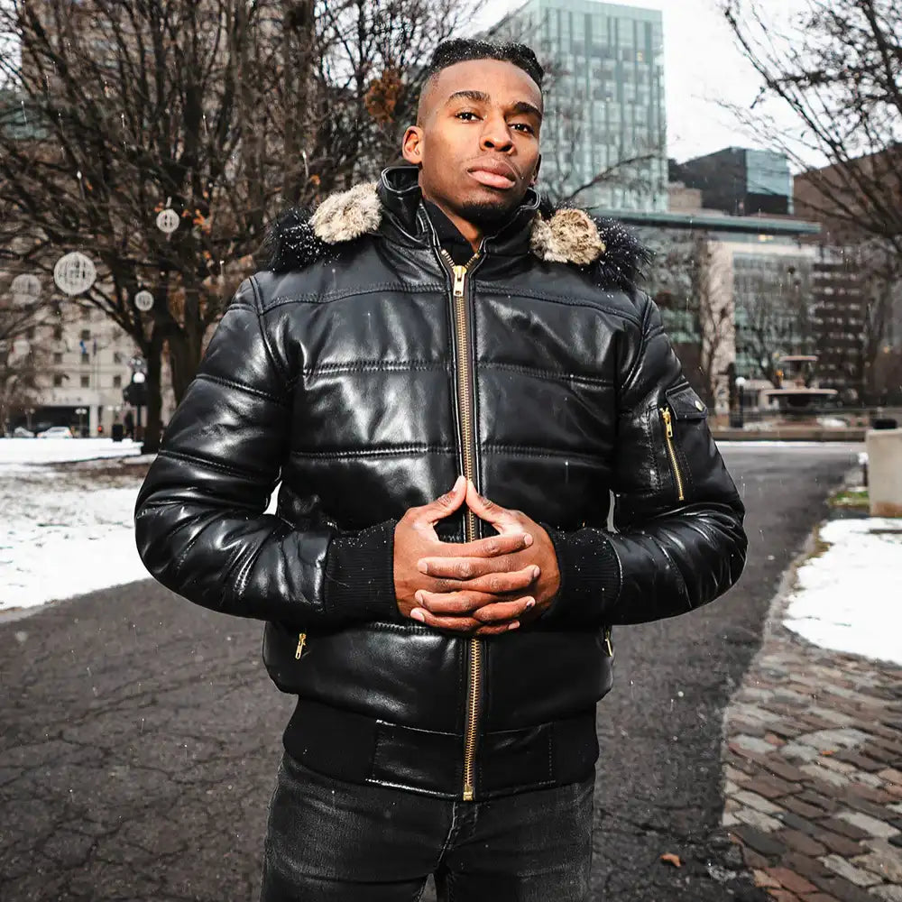 A model wearing the Ash hooded leather puffer jacket with a streetwear outfit, showcasing the urban aesthetic and mid-weight volume.