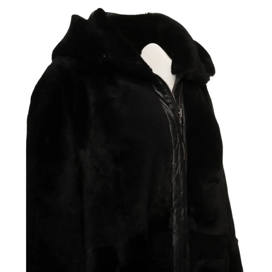 Side view of the Avalon Black oversized reversible sheepskin long coat, highlighting its sleek silhouette and reversible feature for two distinct looks.