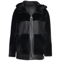 Front view of the Elena oversized jacket showing the smooth black leather exterior with plush shearling trim on the collar and cuffs.