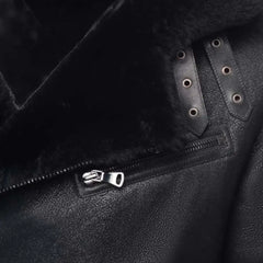 Close-up of a black leather jacket with a brand logo on the chest pocket.