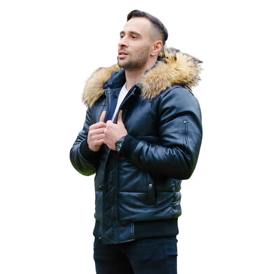 A model wearing the Traynor leather puffer jacket with the hood up, demonstrating the heavy insulation and mid-waist winter silhouette.