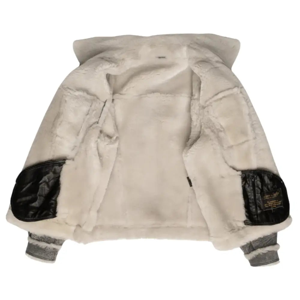 Interior shot of Aiden's Grey Trucker Jacket, highlighting the plush white shearling lining. The jacket is open, displaying the soft, warm fur lining throughout the inner surface, with black leather accents on the elbows.