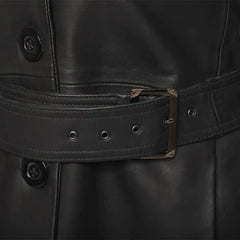 Close-up of a black leather jacket with a belt and buttons.