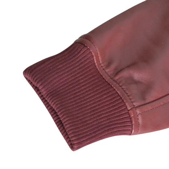 Detailed view of the ribbed knitted cuffs and hem of Justin's Burgundy A2 Bomber leather jacket, showing the jacket’s stylish and comfortable fit.