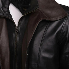 Close-up of the Byrnes aviator jacket featuring a contrast brown spread collar against a black leather body.