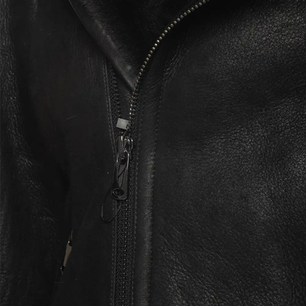 Close-up of the distressed leather on Carter's biker bomber jacket zipper.