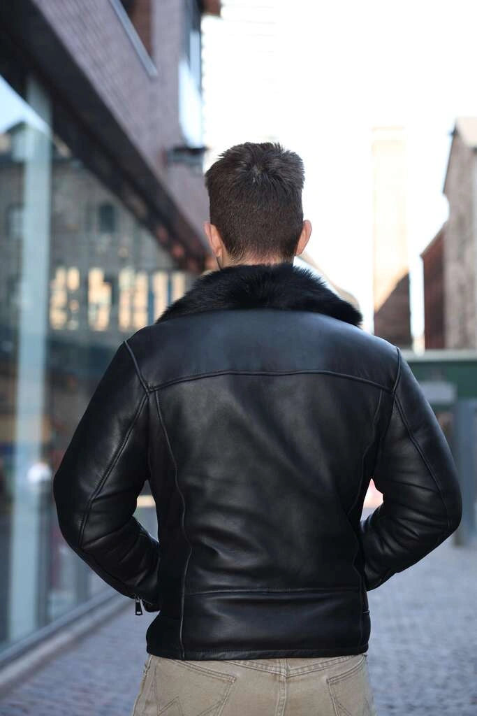 Back view of a Person wearing a Carter's Toscana Shearling Leather Biker Jacket on a city street.