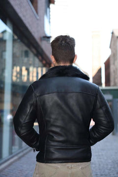 Back view of a Person wearing a Carter's Toscana Shearling Leather Biker Jacket on a city street.