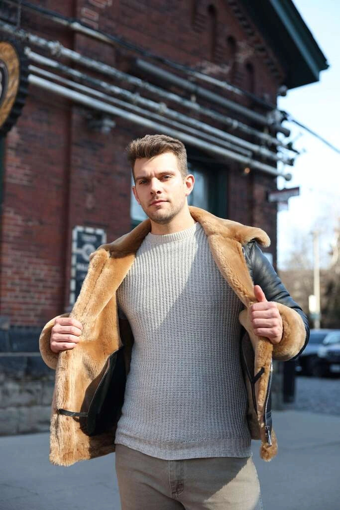 Man wearing Classic Ginger Brown B3 Bomber Aviator Shearling Jacket in an urban setting.