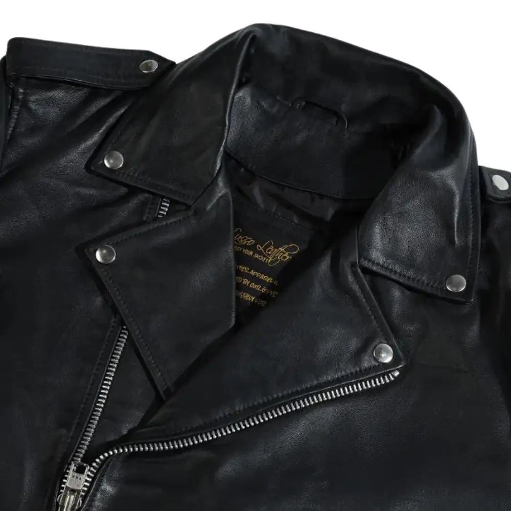 Close-up of the epaulette shoulder straps on the classic leather biker jacket with visible branding on a white background