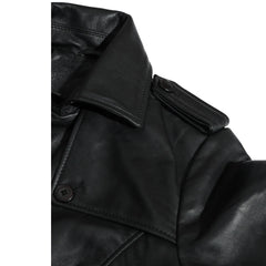 Close-up of a black leather coat with a button on a white background