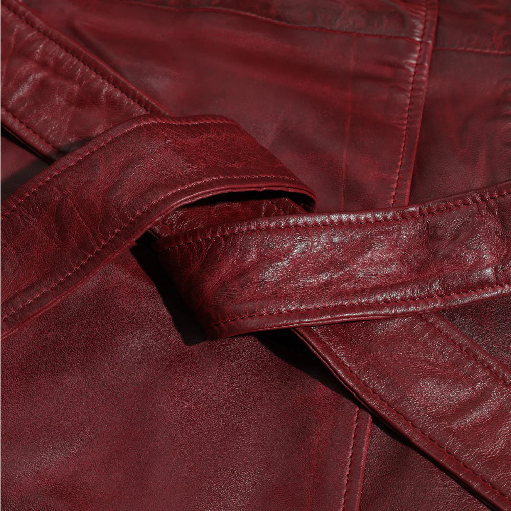 Close-up of a red leather jacket belt with visible stitching