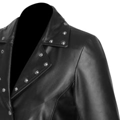 Close-up of the neckline and shoulder construction with studded details of the Jennifer asymmetrical dress on a white background.