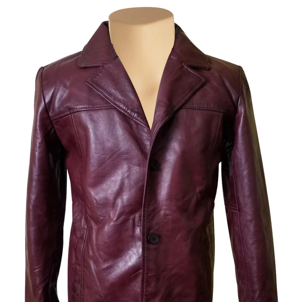 Close-up detail of the maroon leather texture on Krueger's blazer, focusing on the premium button hardware, reinforced stitching, and the soft sheen of the leather grain.