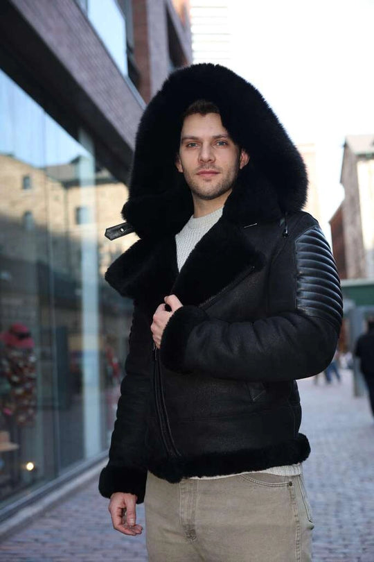 Man wearing Lucas Black Aviator Bomber Shearling Jacket with fur hood in an urban setting
