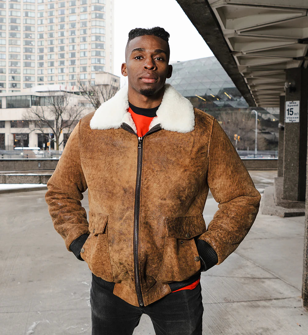 Lucian's brown leather A2 bomber shearling jacket worn by a model in an urban outdoor lifestyle setting.