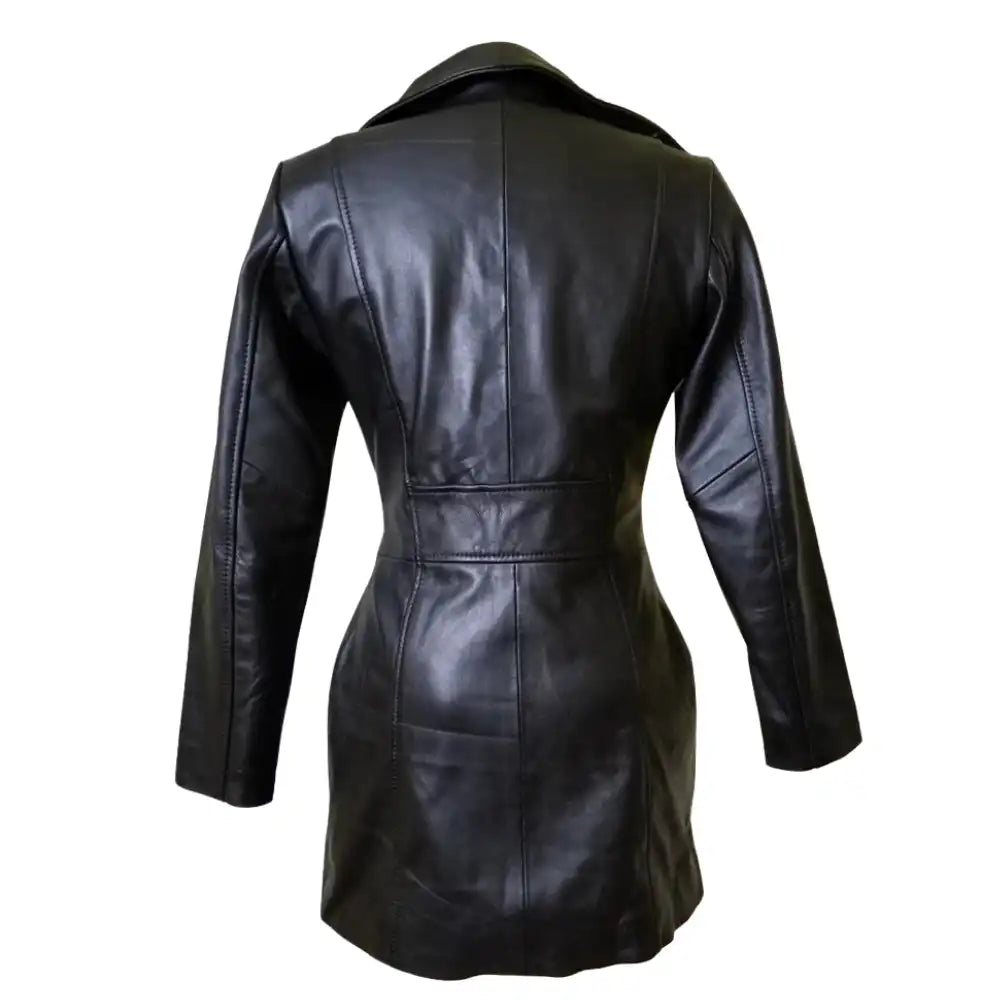 Rear view of Nelly's long leather coat highlighting the clean longline silhouette and center back vent for mobility.