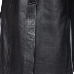 Close-up of a black leather jacket with visible texture and stitching.