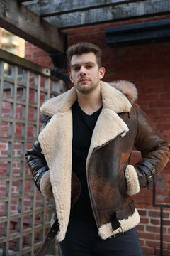 Man wearing Rocco vintage brown aviator shearling jacket with fur lining in an urban setting.