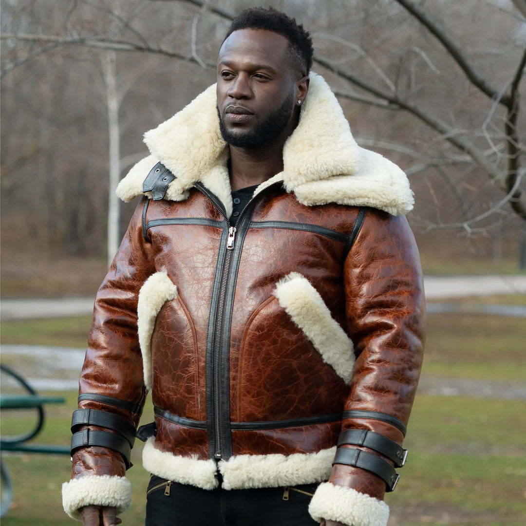Man wearing a Terry Gretzky Vintage Oxblood bomber jacket with double collar with white fur lining in an outdoor setting.