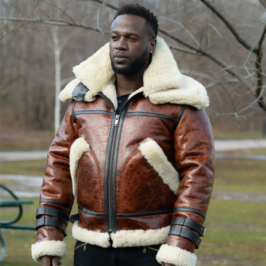 Man wearing a Terry Gretzky Vintage Oxblood bomber jacket with double collar with white fur lining in an outdoor setting.