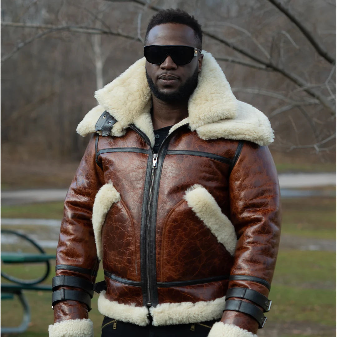 Man wearing a Terry Gretzky Vintage Oxblood bomber jacket with double collar with black glasses white fur lining in an outdoor setting.