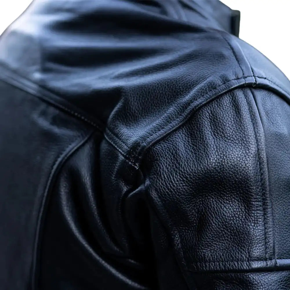 Close-up of the dual-density external shoulder and elbow sliders with "The Real Racer" branding on high-abrasion leather.