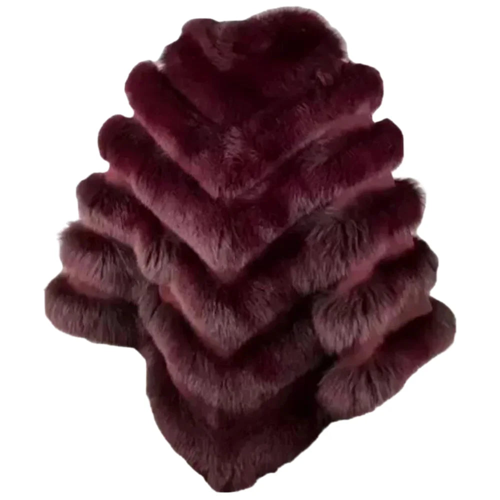 A side profile of a women's burgundy fox fur cape, highlighting the thickness of the fur layers and the comfortable arm-opening design.