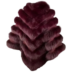 A side profile of a women's burgundy fox fur cape, highlighting the thickness of the fur layers and the comfortable arm-opening design.
