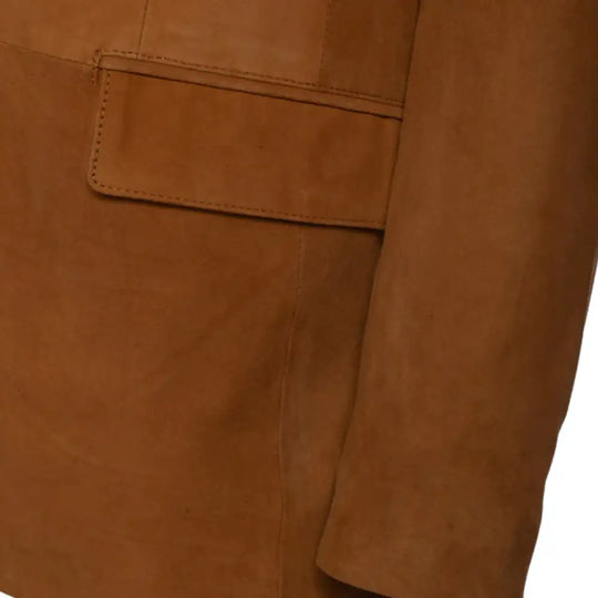 Close-up of a tan suede leather blazer with a pocket and sleeves detail on a white background